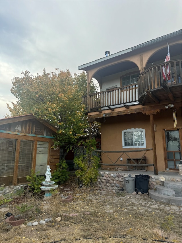 rear view of house with a balcony