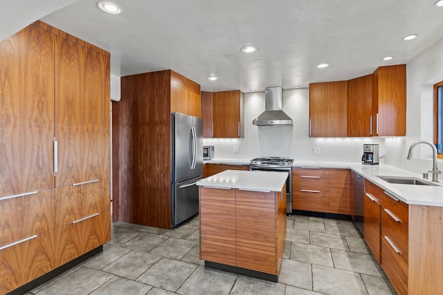 kitchen with wall chimney exhaust hood, a center island, light countertops, stainless steel appliances, and a sink