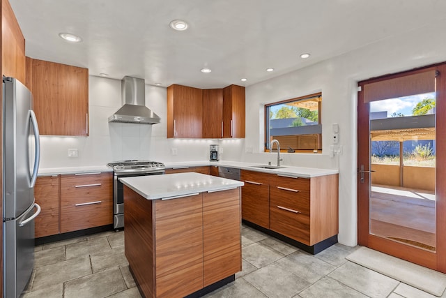 kitchen with a center island, a healthy amount of sunlight, wall chimney range hood, and stainless steel appliances