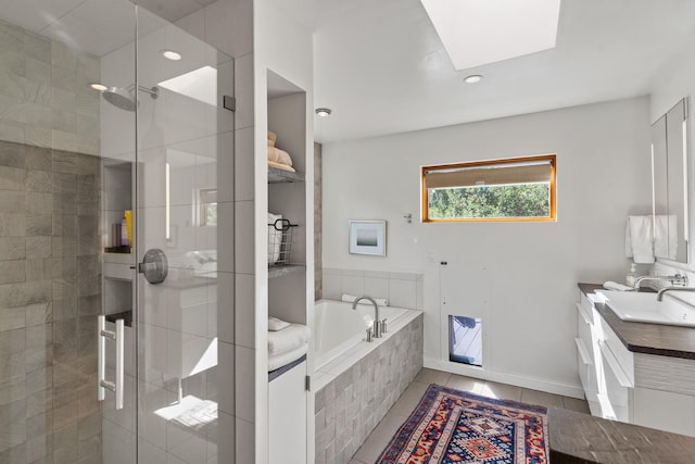 full bath featuring tile patterned flooring, a skylight, vanity, a bath, and a stall shower