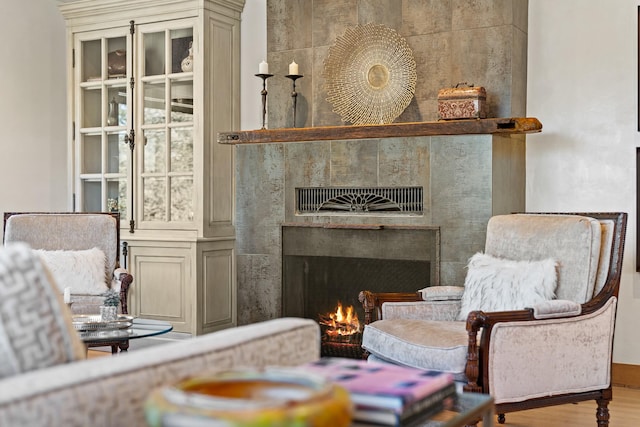 living area with a fireplace and wood finished floors