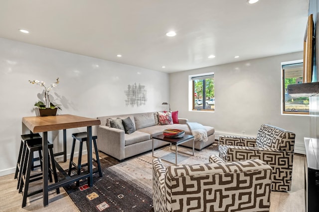 living area featuring baseboards and recessed lighting