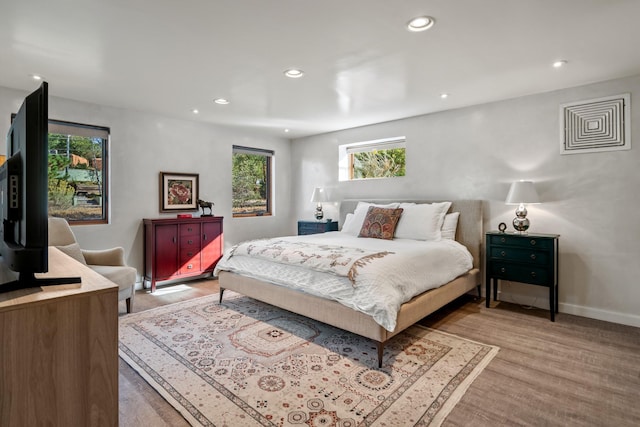 bedroom featuring light wood-type flooring, baseboards, and recessed lighting