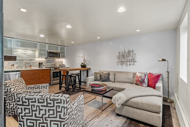 living room with light hardwood / wood-style floors and sink