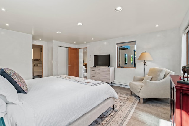 bedroom with light wood-type flooring and recessed lighting