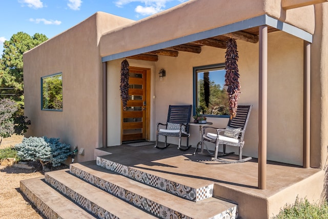 property entrance featuring a porch