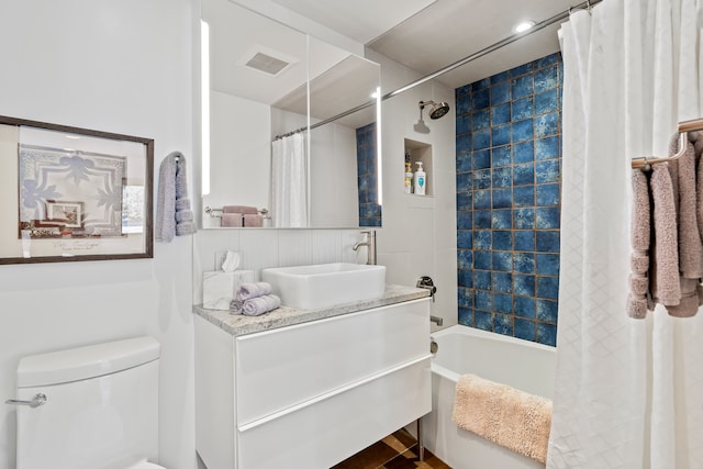 full bathroom featuring shower / bath combination with curtain, vanity, and toilet