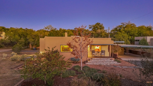 back of property at dusk with stucco siding