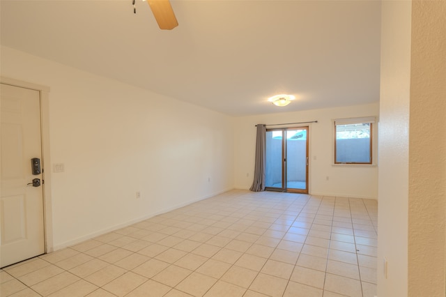 tiled empty room with ceiling fan