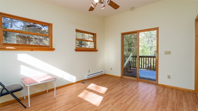 empty room with light hardwood / wood-style flooring, a baseboard radiator, ceiling fan, and plenty of natural light