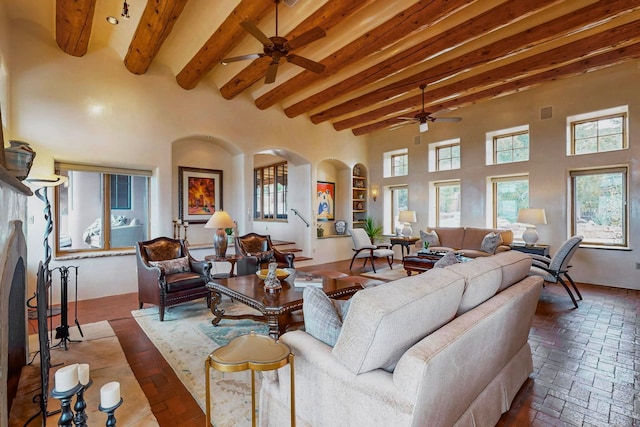 living room with ceiling fan and beamed ceiling