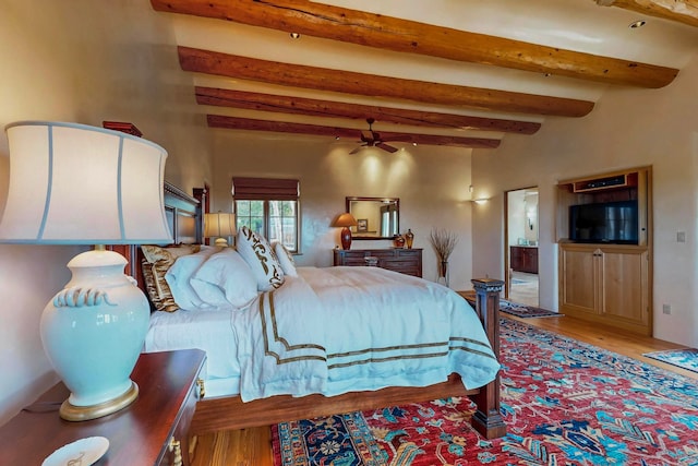 bedroom with hardwood / wood-style flooring and beam ceiling