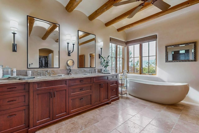 bathroom with vanity, ceiling fan, a washtub, and beamed ceiling