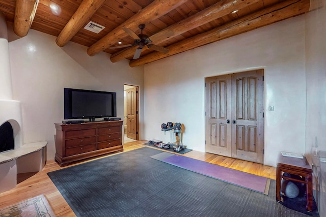 exercise room featuring ceiling fan, wooden ceiling, and light wood-type flooring