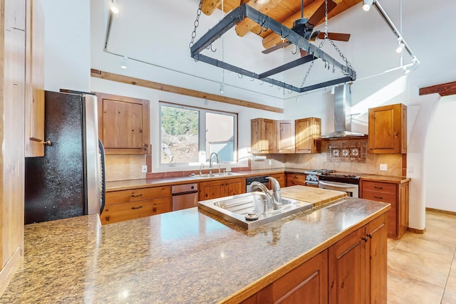 kitchen featuring sink, wall chimney exhaust hood, stainless steel appliances, decorative backsplash, and light tile patterned floors