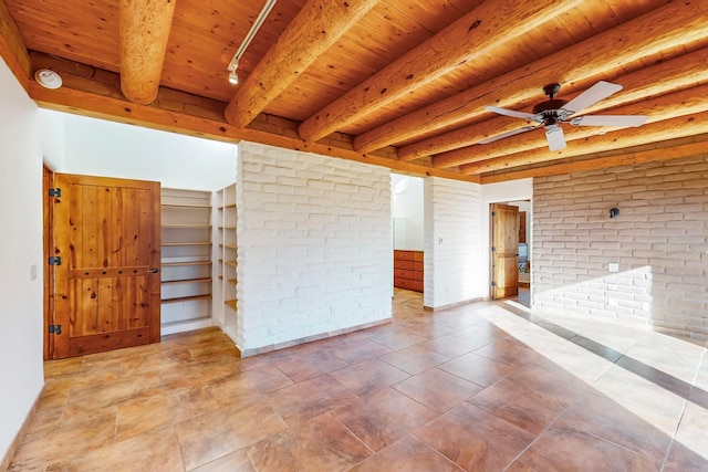 unfurnished room featuring beamed ceiling, wood ceiling, and brick wall