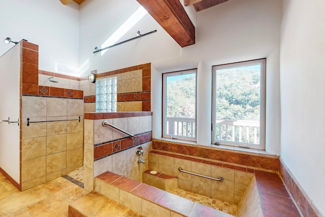 bathroom featuring tile patterned floors, beamed ceiling, and tiled shower