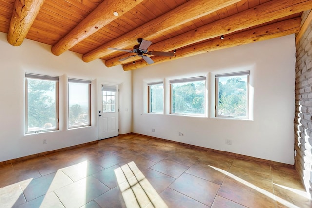 interior space with tile patterned floors, ceiling fan, beam ceiling, and wooden ceiling