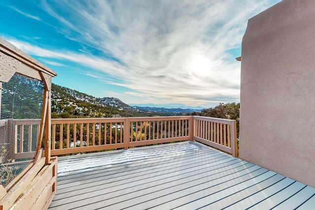 wooden terrace featuring a mountain view