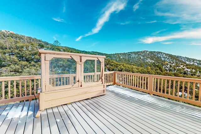 wooden deck with a mountain view