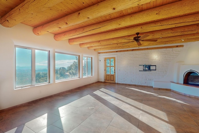 unfurnished living room with beamed ceiling, wooden ceiling, and light tile patterned floors