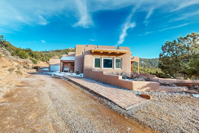 pueblo-style home with a garage