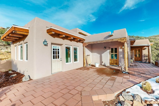 rear view of property featuring a patio area