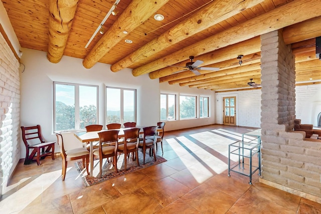 tiled dining room featuring decorative columns, ceiling fan, wooden ceiling, and beam ceiling