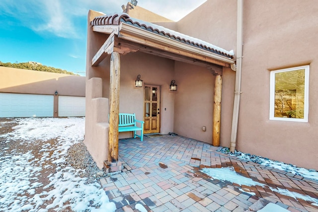 exterior space with a garage and a patio