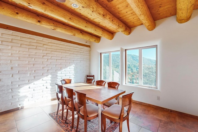 dining room featuring beamed ceiling, wooden ceiling, and light tile patterned floors