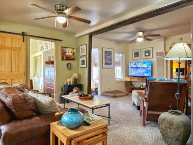 carpeted living room featuring a barn door and ceiling fan