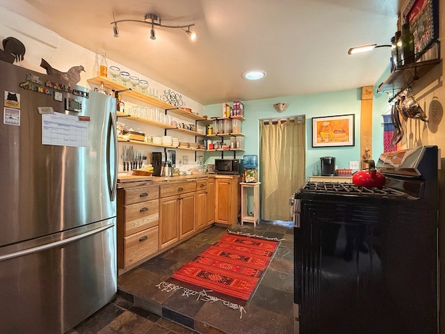 kitchen featuring light brown cabinetry and stainless steel appliances