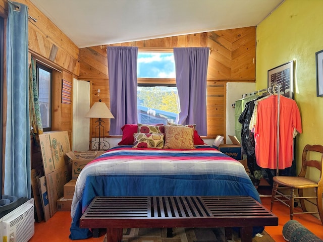 bedroom with wood walls and lofted ceiling