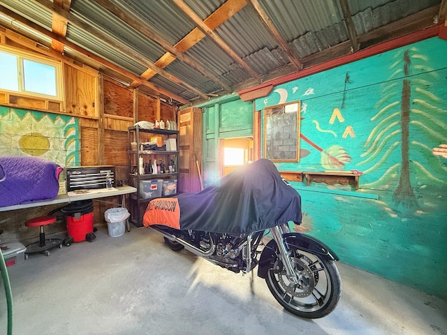 bedroom featuring multiple windows and concrete flooring