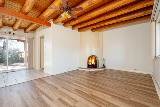 unfurnished living room featuring beamed ceiling, light hardwood / wood-style floors, ceiling fan, and wood ceiling