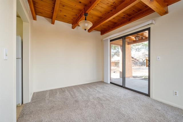 carpeted spare room featuring beamed ceiling and wooden ceiling