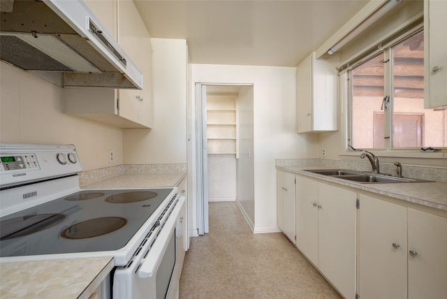 kitchen featuring white cabinets, white range with electric stovetop, and sink