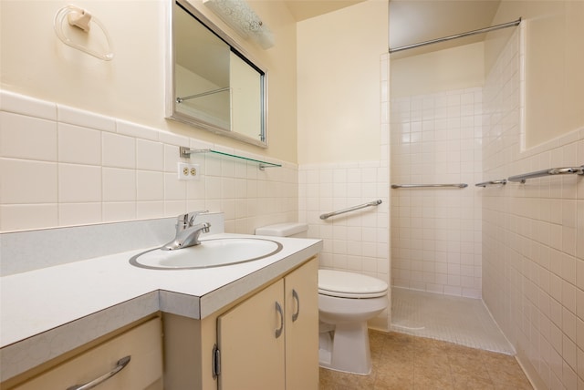 bathroom featuring tile patterned floors, vanity, tile walls, and toilet