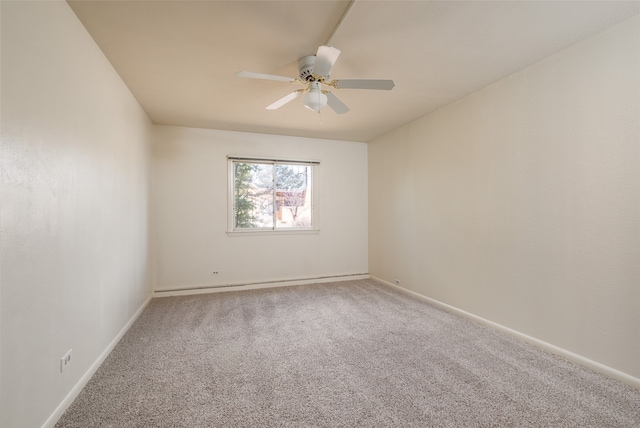 carpeted spare room featuring ceiling fan