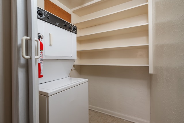 clothes washing area with stacked washer and dryer