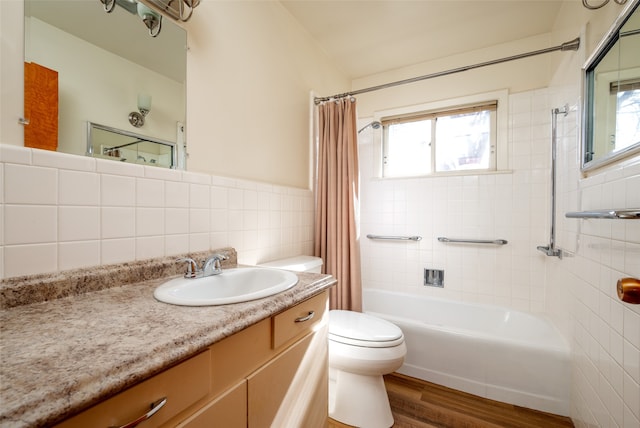 full bathroom with shower / bath combo, wood-type flooring, toilet, vanity, and tile walls