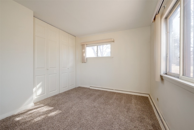 unfurnished bedroom featuring a closet, carpet floors, and multiple windows