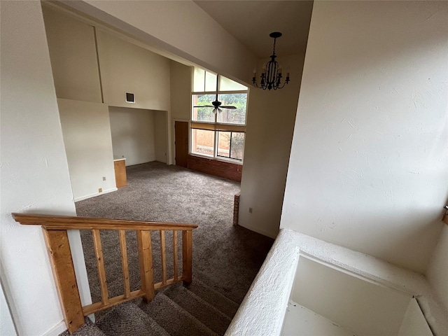 interior space with dark carpet and a notable chandelier