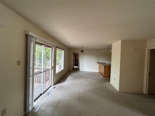 unfurnished living room with light carpet