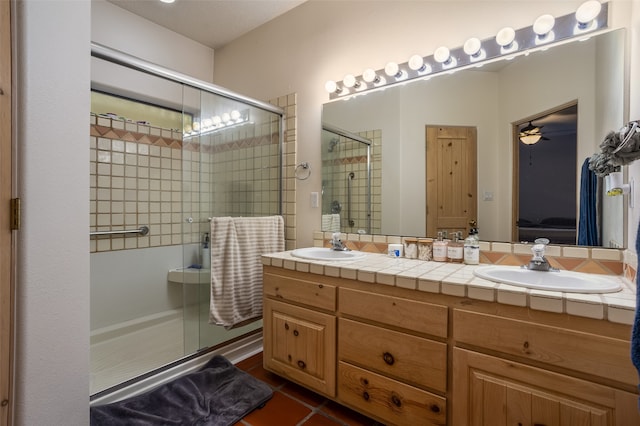 bathroom with tile patterned floors, ceiling fan, walk in shower, and vanity