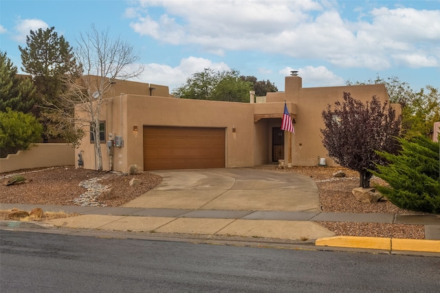 pueblo-style house with a garage