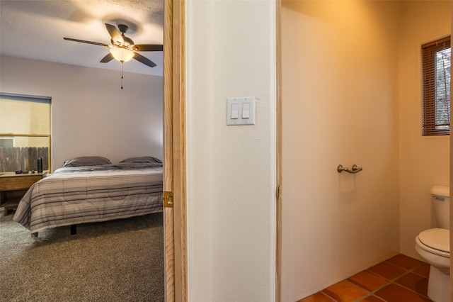 carpeted bedroom featuring a textured ceiling and ceiling fan