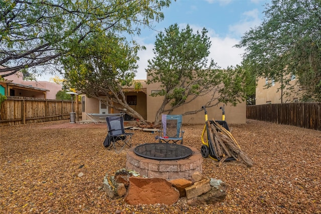 view of yard with a fire pit