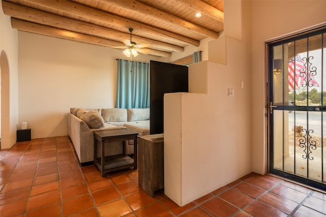 living room with ceiling fan, tile patterned flooring, beamed ceiling, and wood ceiling