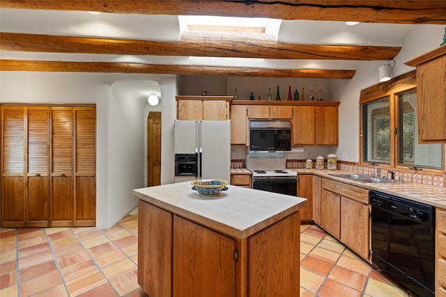 kitchen featuring beam ceiling, sink, light tile patterned floors, a kitchen island, and black appliances